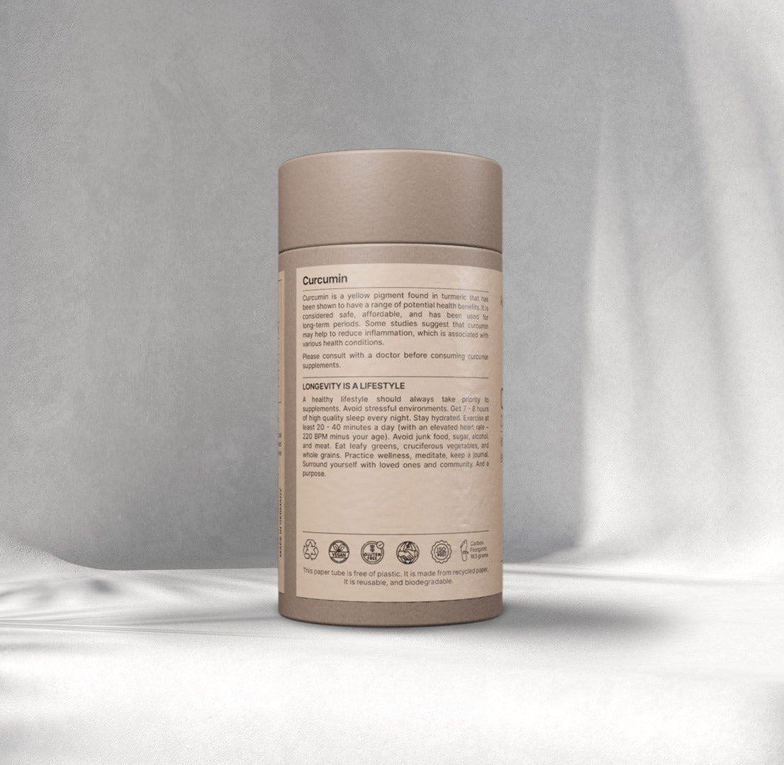 A cylindrical cardboard container labelled "Curcumin" on a soft Gray background. The label details health benefits and lifestyle tips. Eco-friendly symbols are displayed.