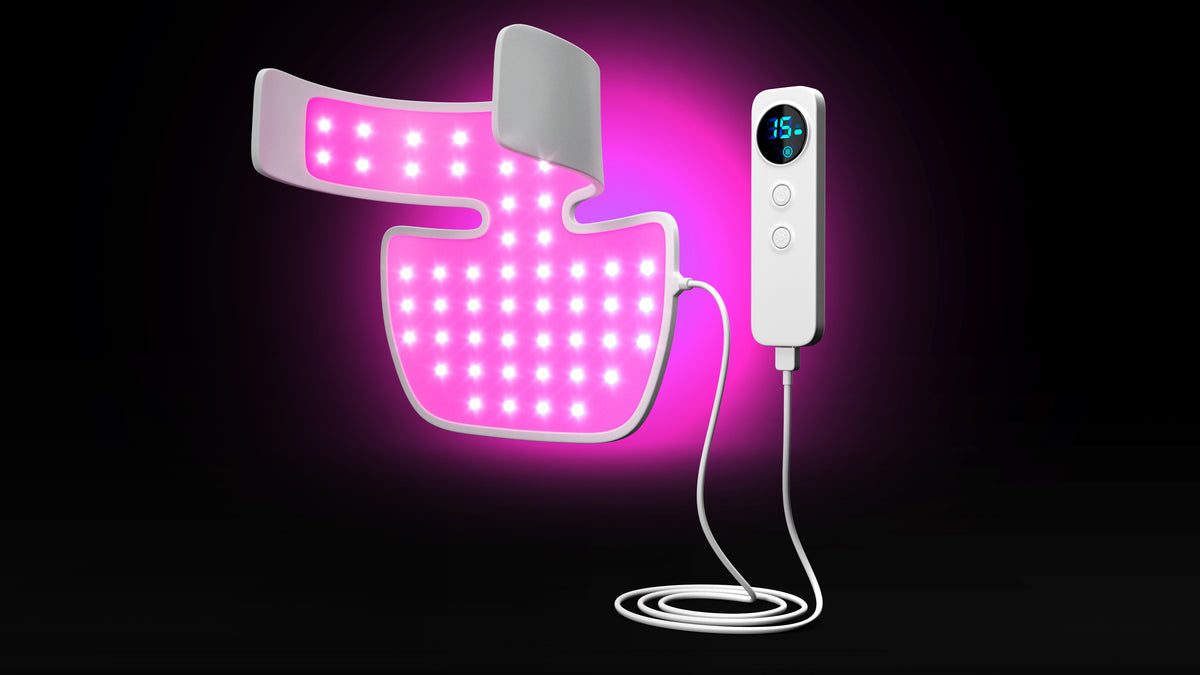 Neck and chest LED therapy panel glowing magenta-pink in Mode 4, displayed on a black background with its wired controller